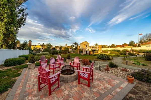a view of a patio with a table and chairs and potted plants