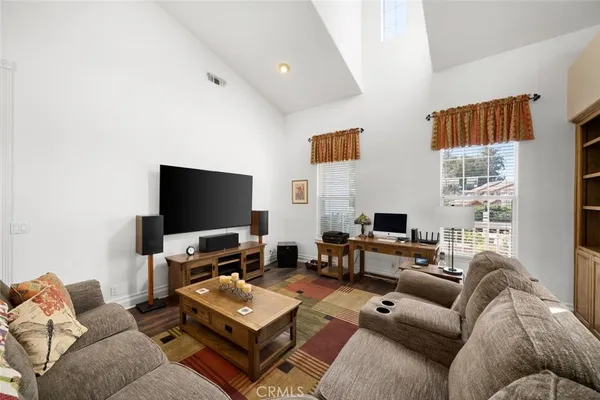 a living room with fireplace furniture and a rug