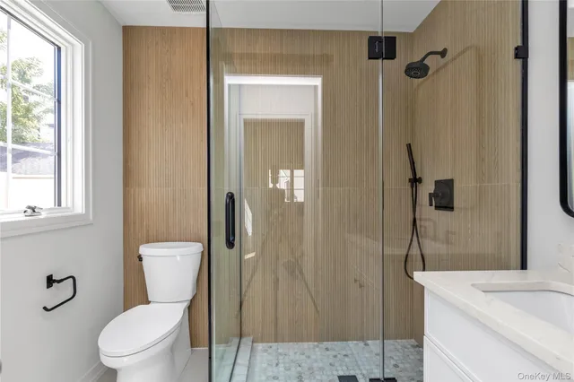 a white toilet sitting next to a bathroom sink