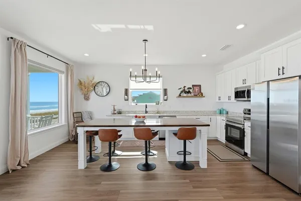 a living room with furniture and kitchen view
