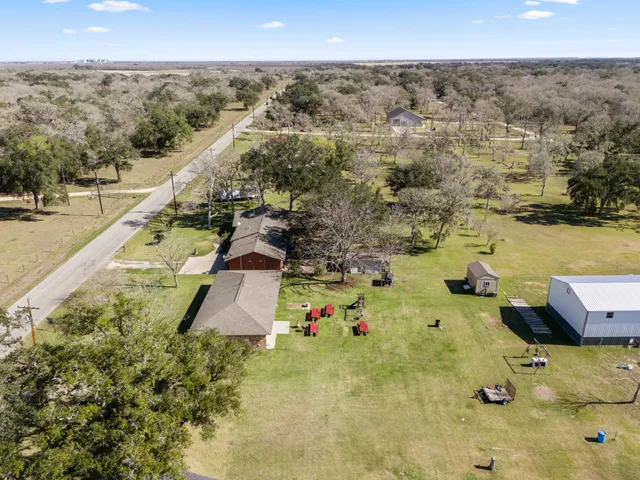 a dining room with furniture a chandelier and window