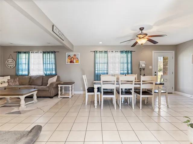 a kitchen with granite countertop a stove a sink and a refrigerator