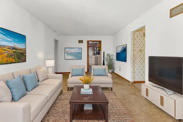 a view of a big room with entryway and kitchen view