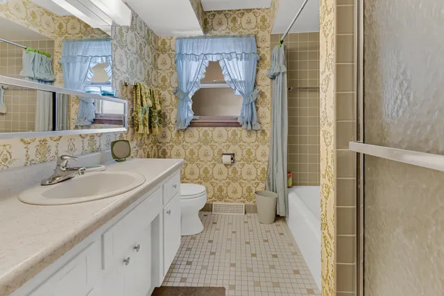 a bedroom with a bed and a potted plant