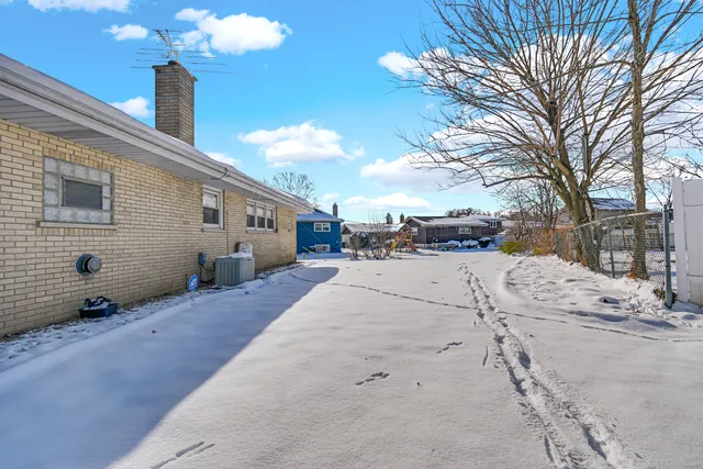 a view of a house with a snow on the road
