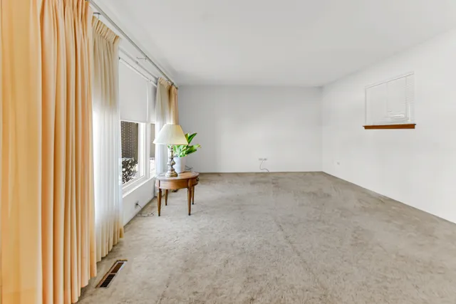 a view of a hallway with furniture and a window