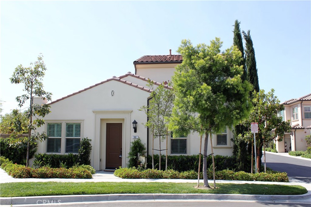 100 Desert Bloom Irvine, CA 92618 - Photo 1 of 15 a front view of a house with a garden