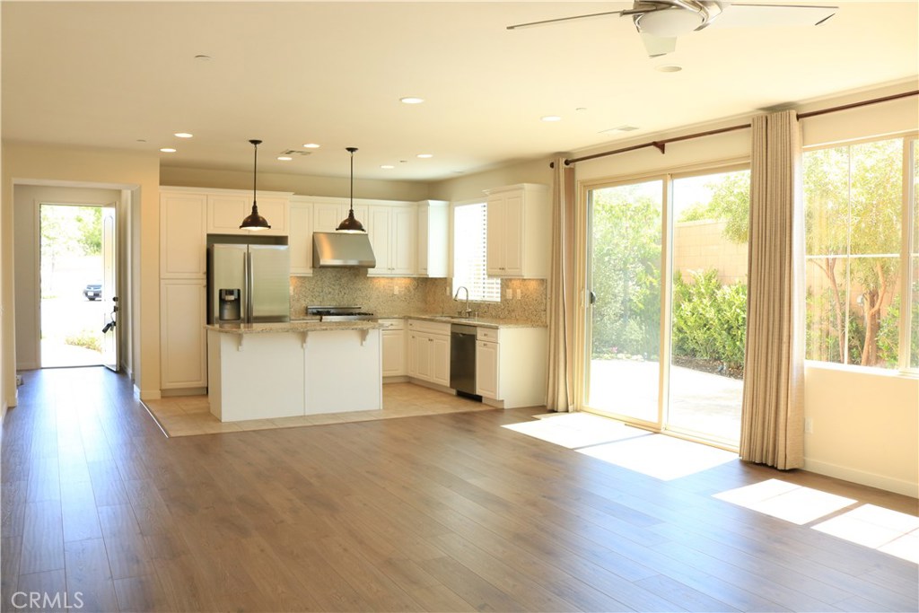 100 Desert Bloom Irvine, CA 92618 - Photo 3 of 15 a view of a kitchen with refrigerator and wooden floor