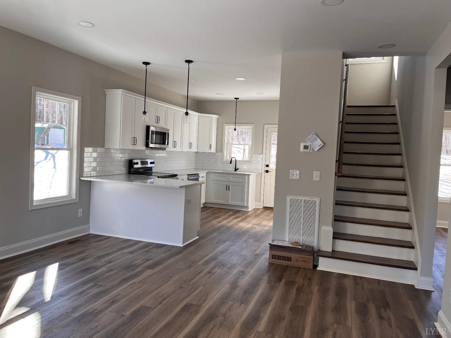 190 Hawkins Road Evington, VA 24550 - Photo 3 of 36 a kitchen with stainless steel appliances a refrigerator and wooden floor