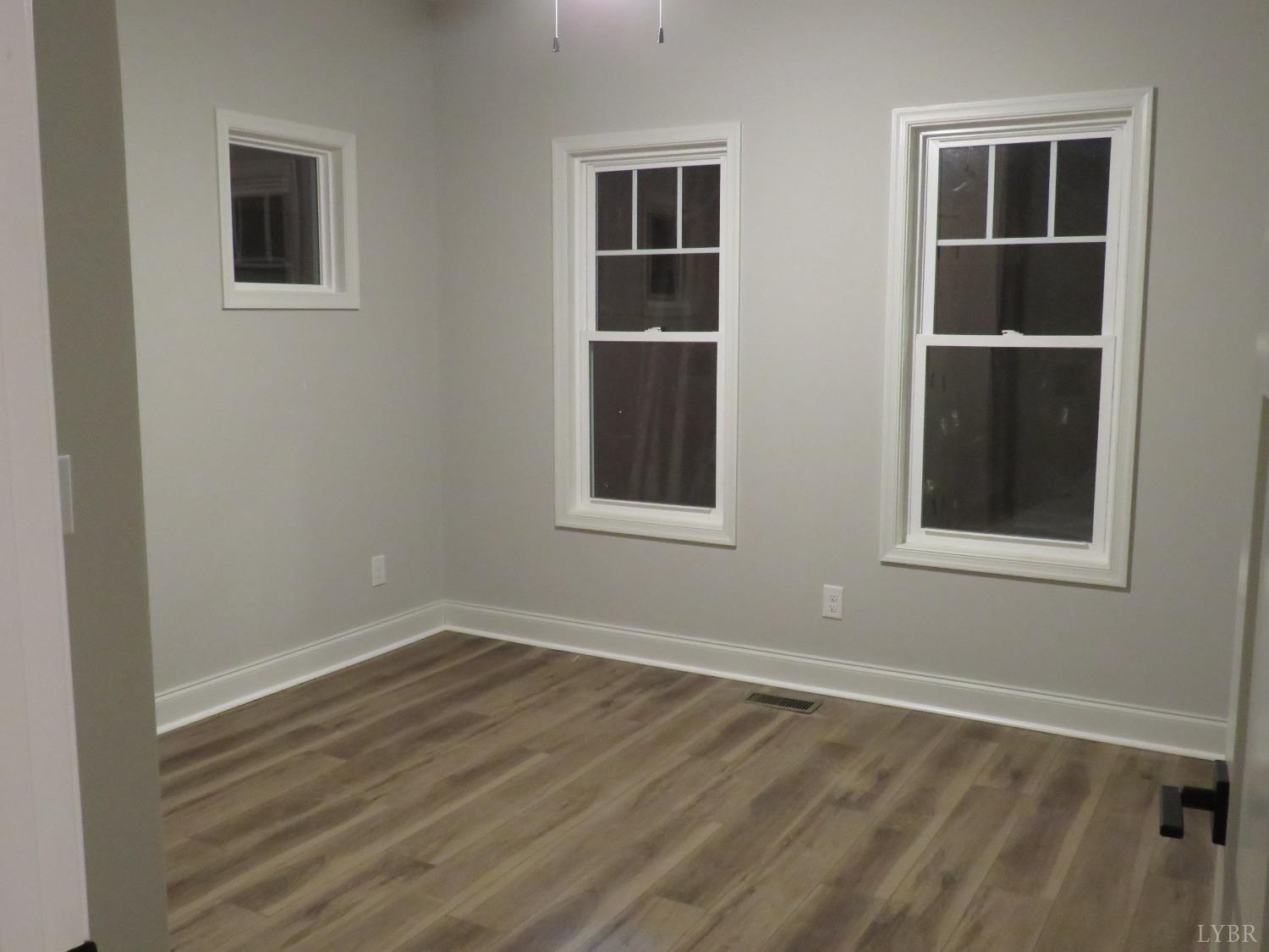 190 Hawkins Road Evington, VA 24550 - Photo 8 of 36 a view of empty room with windows and entryway