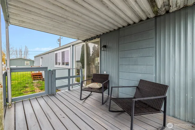 a roof deck with table and chairs and wooden floor