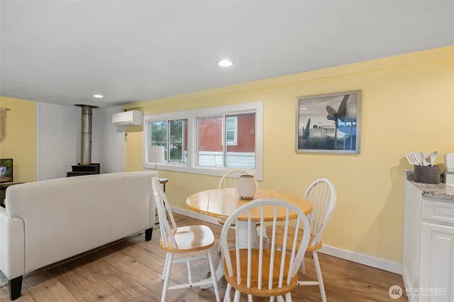 a living room with furniture a table and wooden floor