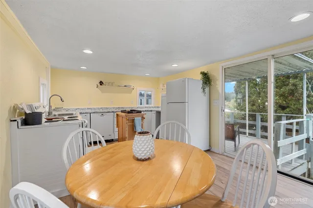 a dining room with furniture and a large window