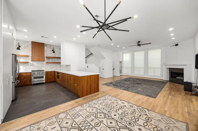 a large bedroom with a bed and a chandelier