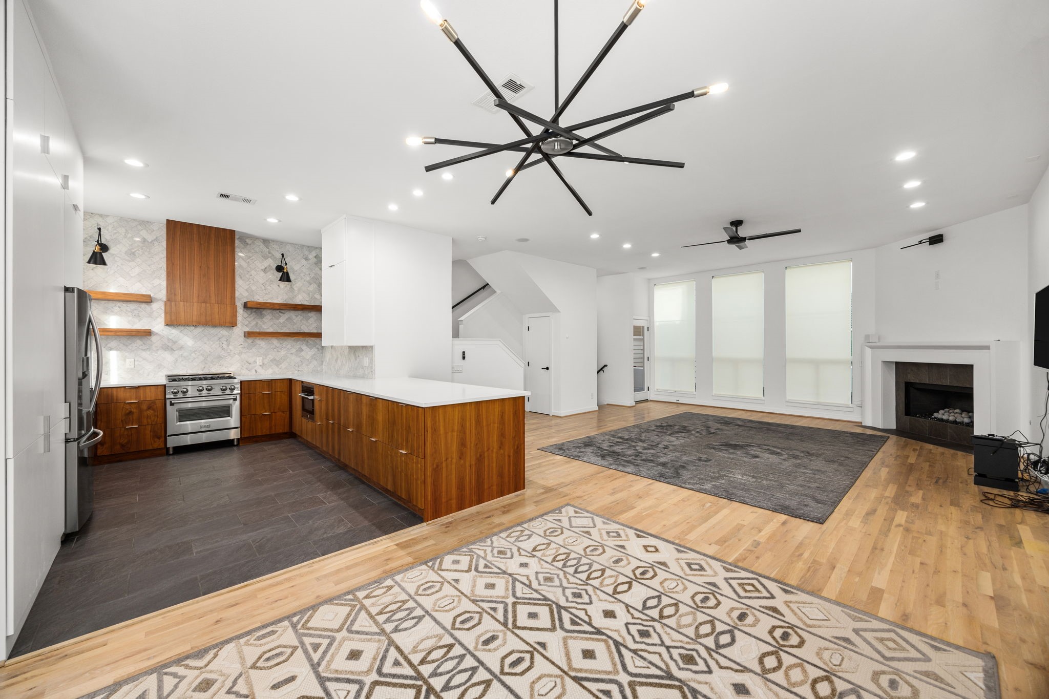 a large bedroom with a bed and a chandelier