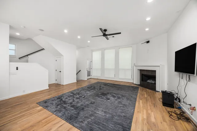 a view of a living room a flat screen tv and a fireplace