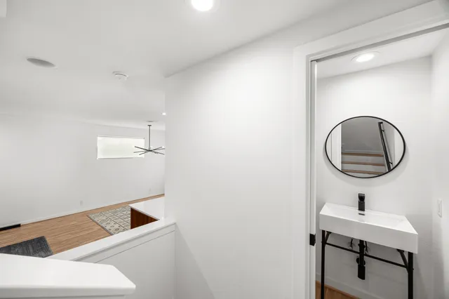 a bathroom with a sink a mirror and vanity