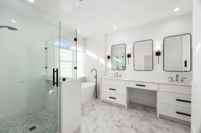 a bathroom with a double vanity sink mirror and shower