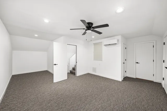 a view of an empty room with a ceiling fan