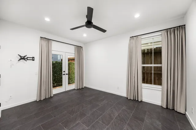 a view of a big room with wooden floor and windows