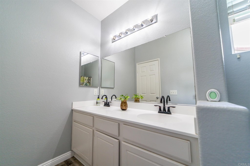 31047 Rose Circle Murrieta, CA 92563 - Photo 14 of 20 a bathroom with a sink and a mirror