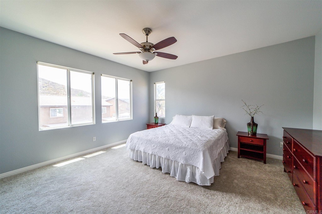 31047 Rose Circle Murrieta, CA 92563 - Photo 8 of 20 a spacious bedroom with a bed and a window