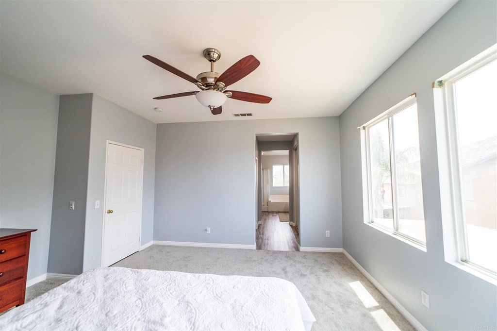 31047 Rose Circle Murrieta, CA 92563 - Photo 9 of 20 a bedroom with a large bed and a large window