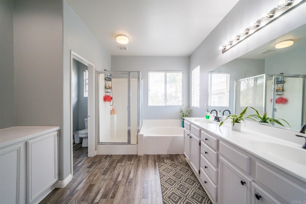 31047 Rose Circle Murrieta, CA 92563 - Photo 10 of 20 a bathroom with a bathtub a sink a toilet and a shower