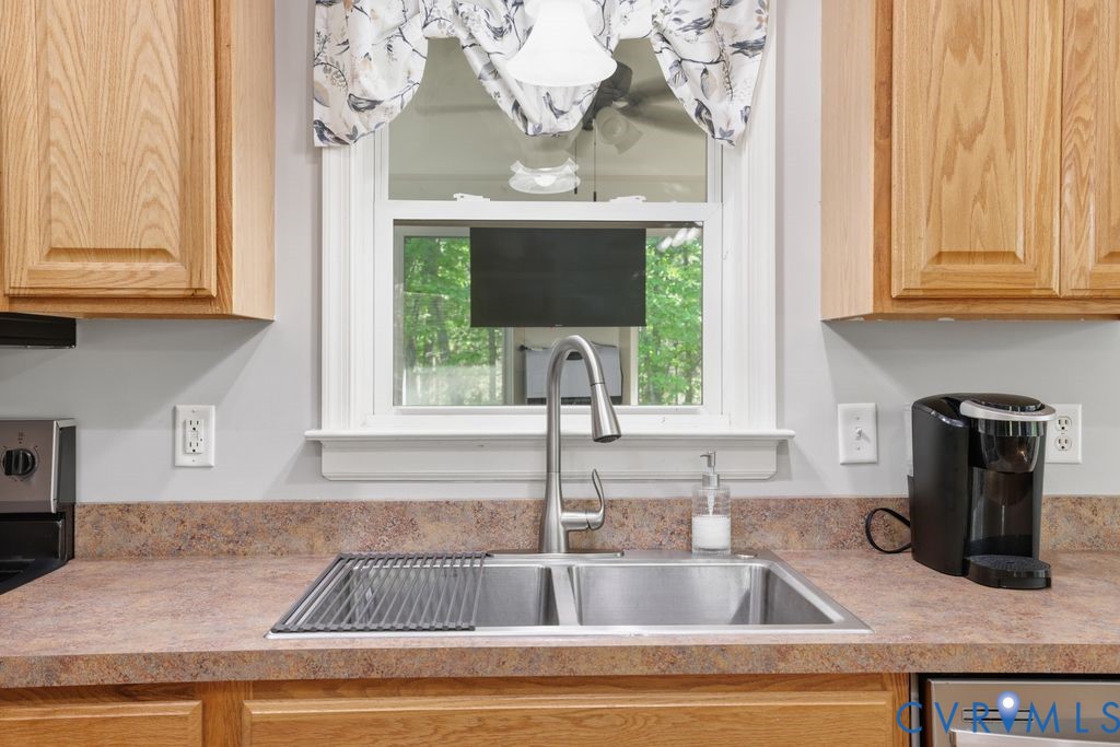 5307 St Pauls Church Road Goochland, VA 23063 - Photo 16 of 44 a kitchen with granite countertop a sink and a window