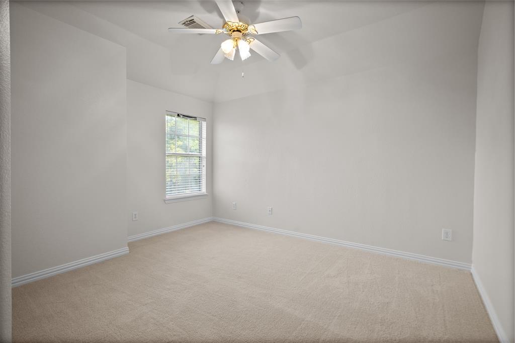 4405 Ridgecove Drive Rowlett, TX 75088 - Photo 25 of 37 Neutral wall paint, carpeted flooring, window with blinds, and ceiling fan