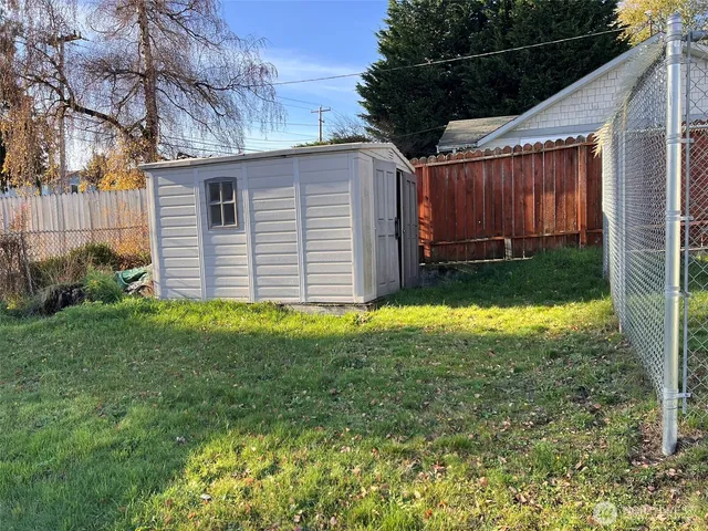 a view of an entryway with wooden floor and cabinet door