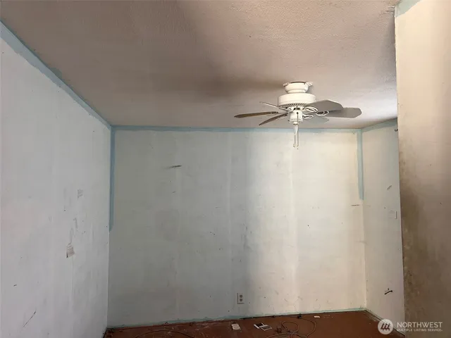 a view of a room with wooden floor and windows