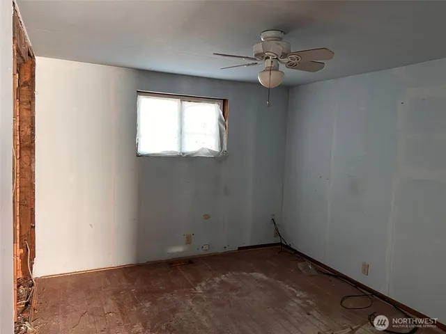 a view of a livingroom with furniture and a window