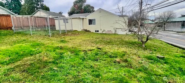 a view of a backyard with wooden fence