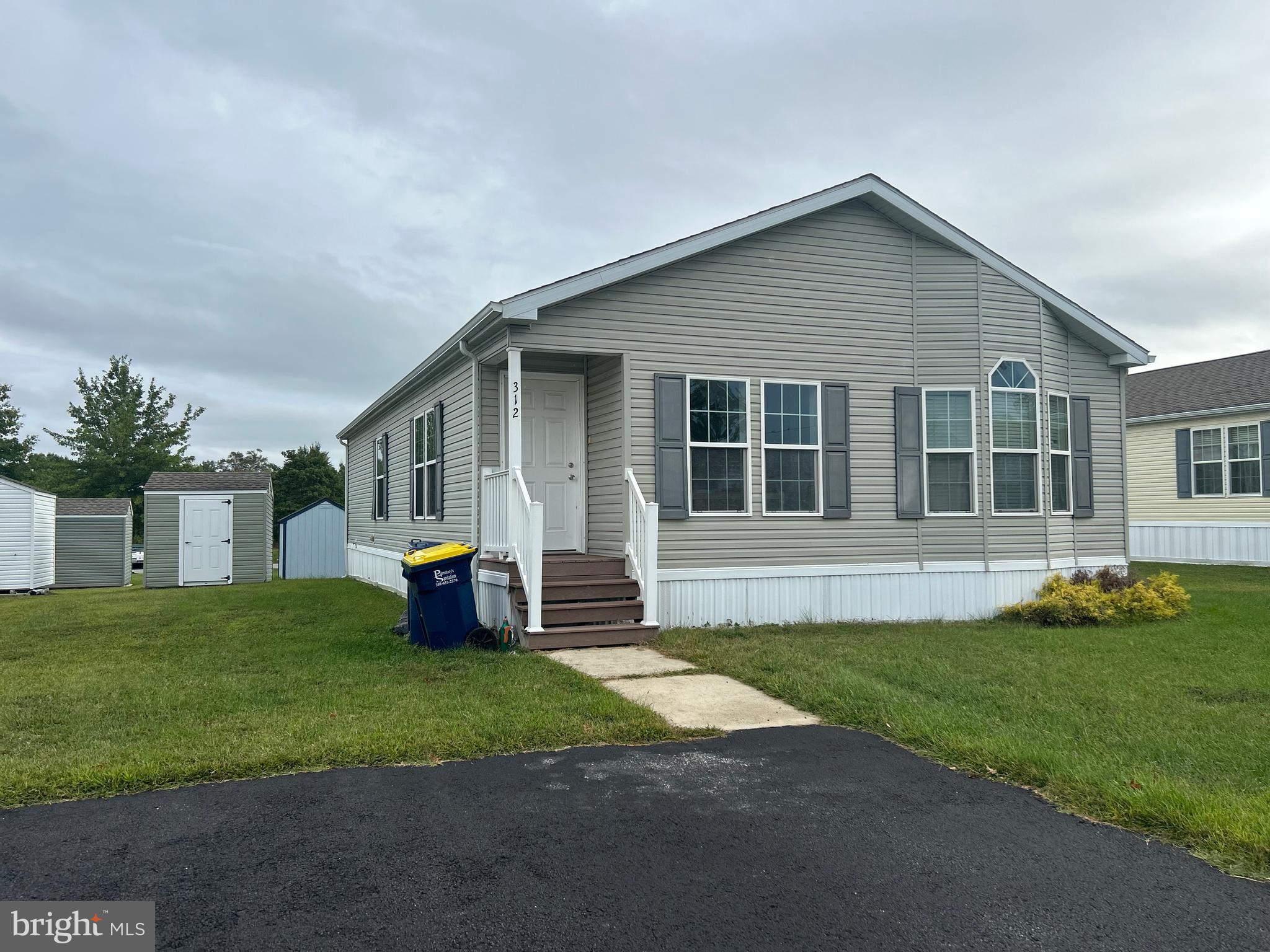 312 Winterset Road Garnet Valley, PA 19060 - Photo 3 of 11 a front view of a house with a garden and trees