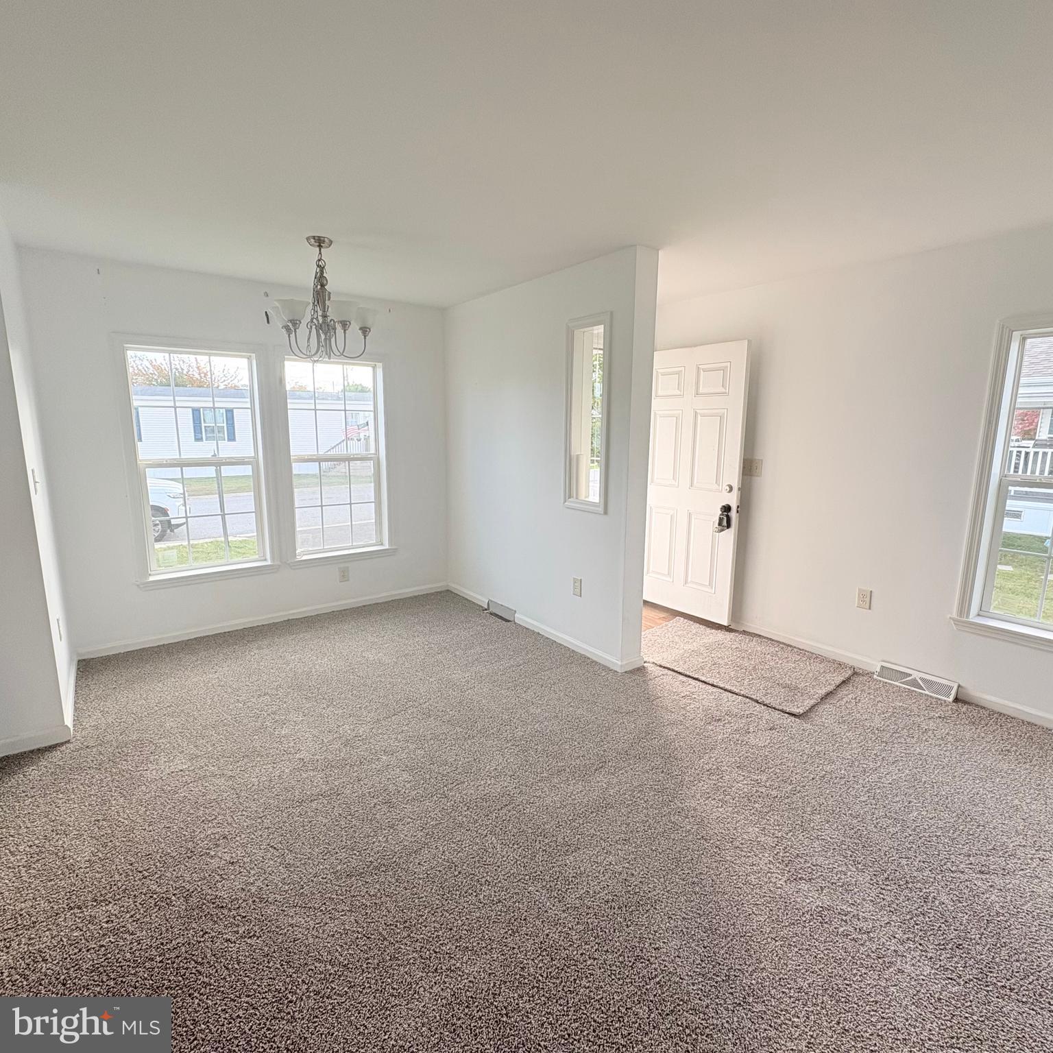312 Winterset Road Garnet Valley, PA 19060 - Photo 8 of 11 an empty room with windows and chandelier fan