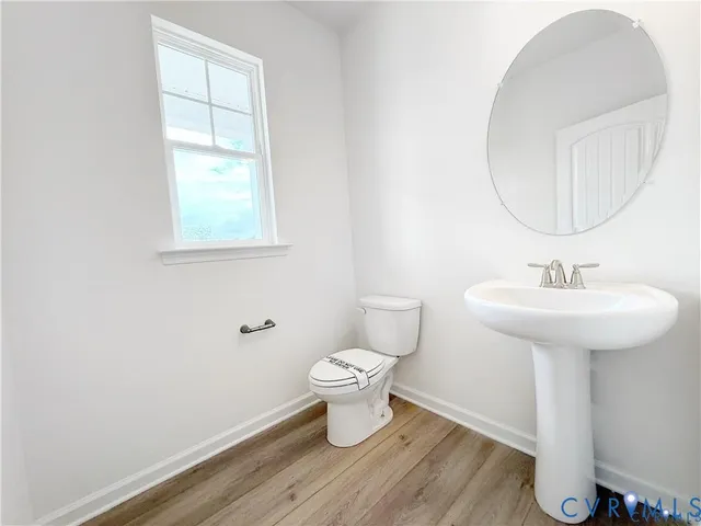 a bathroom with a sink toilet and a mirror