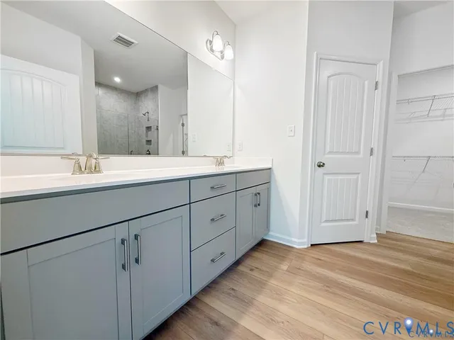 a spacious bathroom with a double vanity sink mirror and