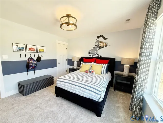 a bedroom with bed and a chandelier