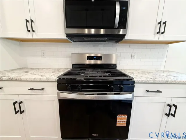 a stove top oven sitting inside of a kitchen