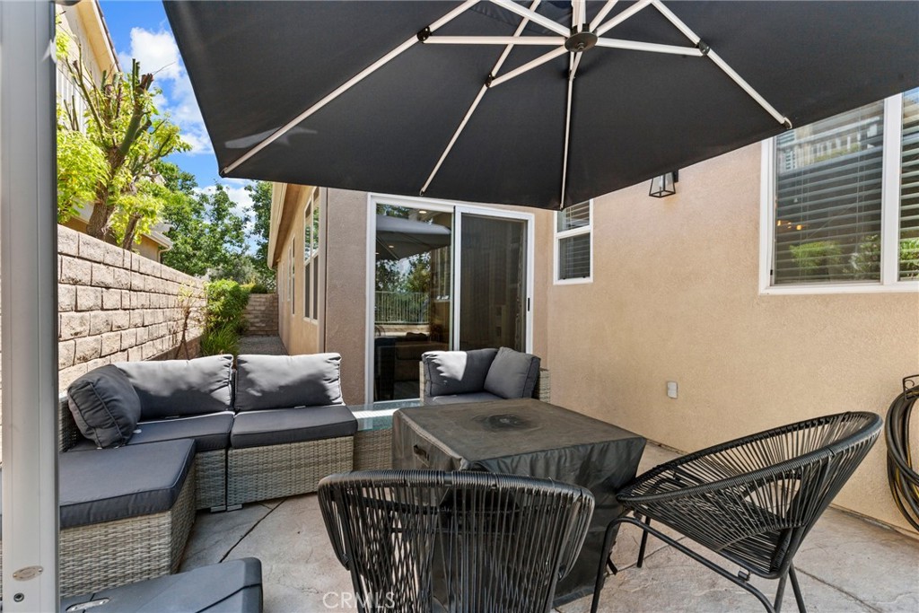 19735 Edmonds Place Saugus, CA 91350 - Photo 24 of 34 a balcony with furniture and umbrella
