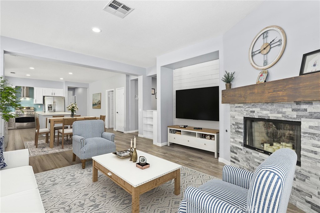 19735 Edmonds Place Saugus, CA 91350 - Photo 6 of 34 a living room with furniture a flat screen tv and a fireplace