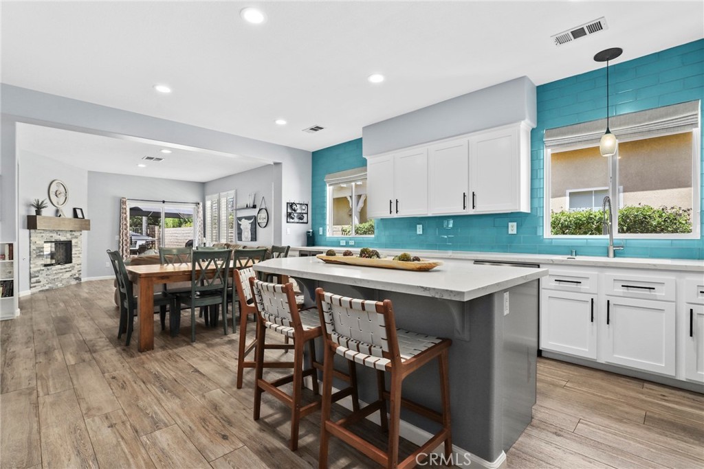 19735 Edmonds Place Saugus, CA 91350 - Photo 8 of 34 a kitchen with a table chairs sink and cabinets