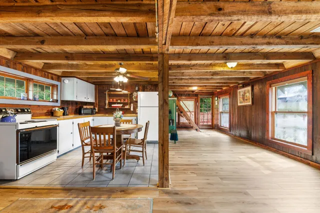 a bedroom with a bed next to a window