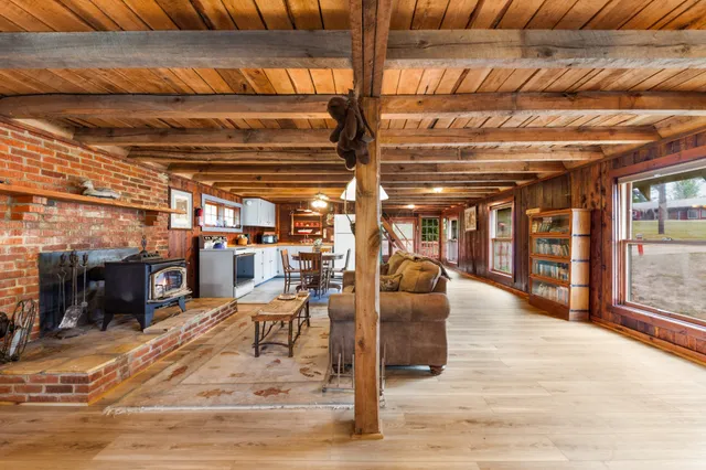 a view of a patio with table and chairs with wooden floor and fence