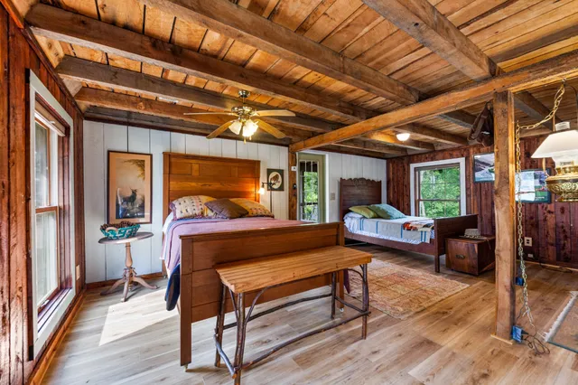 an aerial view of residential houses with outdoor space and lake view