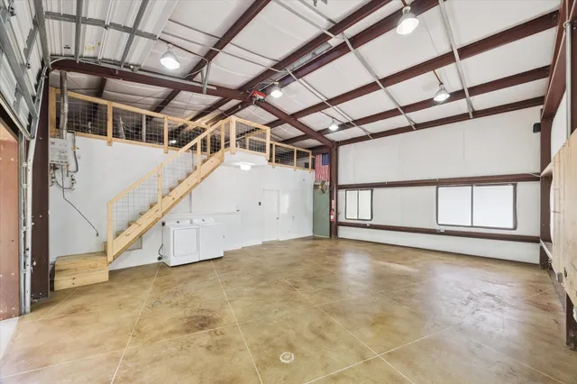 a view of a house with a yard and large trees