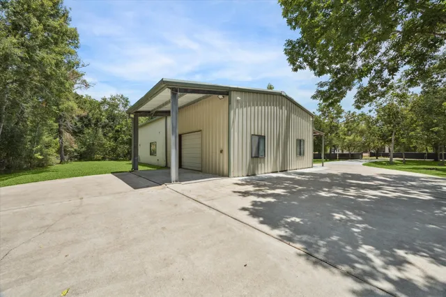 an aerial view of a house with a yard and garden