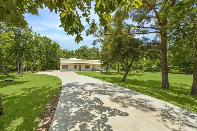 a front view of house with yard and green space