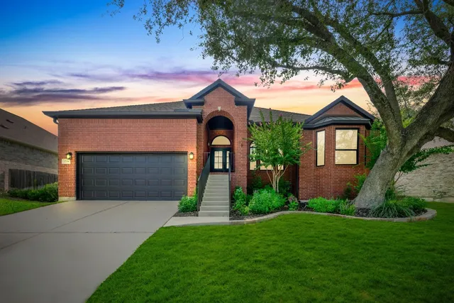 a front view of a house with garden